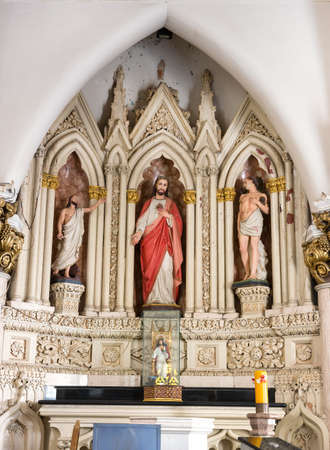 Sacred Heart Statue of Jesus among other statues at the Saint Mary s Basilica in Bangalore のeditorial素材