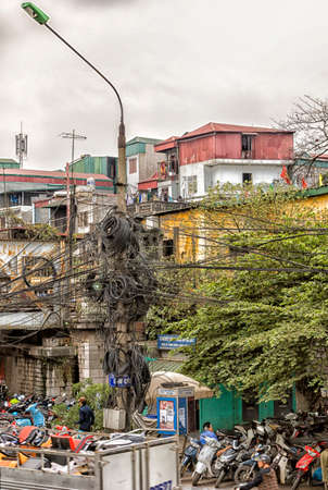 HANOI, VIETNAM - CIRCA MARCH 2012: Street scene showing off nested electrical wiring. Unbelievable...