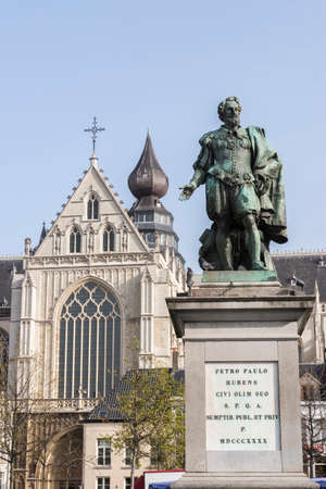 Statue of painter Pieter Paul Rubens on the Groenplaats in Antwerpen with a piece of the Cathedral in the background のeditorial素材