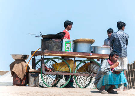 ALLAHABAD, INDIA - CIRCA FEBRUARY 2011  Street kitchen on wheels in a sandy spot along the Ganges River のeditorial素材