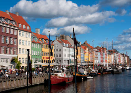 COPENHAGEN, DENMARK - CIRCA SEPTEMBER 2010: The most colorful side of Nyhavn on a sunny afternoon with restaurant row and the sloops in the water.のeditorial素材