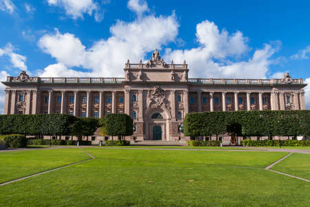STOCKHOLM, SWEDEN - CIRCA SEPTEMBER 2010: Parliament building. Wide shot of the whole impressive building against blue cloudy skies, and green grass in the foreground.のeditorial素材