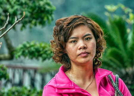 HANOI, VIETNAM - MARCH 6, 2012: Closeup of a Vietnamese young woman wearing a pink vest.のeditorial素材