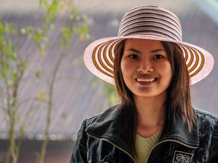 CHUA BAI DINH PAGODA, VIETNAM - MARCH 14, 2012: Closeup of young Vietnamese Woman with traditional straw hat.のeditorial素材