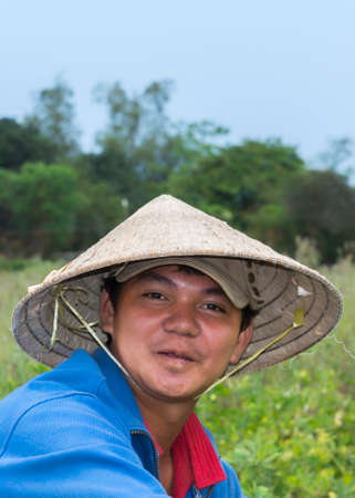 THON TRA QUE, VIETNAM - MARCH 20, 2012: Close up of a young Vietnamese farmer in  his garden near Hoi An.