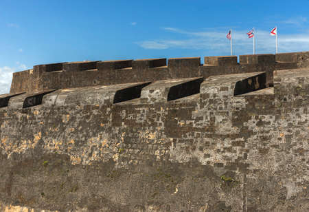SAN JUAN, PUERTO RICO - MARCH 6, 2015: Castillo San Christobal. Three flags above the ramparts: the US flag, the Puerto Rico flag and the Cross of Burgundy, a Spanish military flag used between 16th and 18th century.のeditorial素材