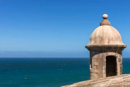 SAN JUAN, PUERTO RICO - MARCH 6, 2015: The Atlantic Ocean behind a corner lookout tower on the ramparts of Castilloe San Felipe del Morro. All under a blue sky.のeditorial素材