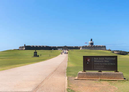 SAN JUAN, PUERTO RICO - MARCH 6, 2015: Official sign announcing the historic site on the side of long path towards the fortification. のeditorial素材