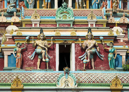 KUMBAKONAM, INDIA - OCTOBER 12, 2013: Mahalingeswarar Temple. Two Dwarapalakas, door keepers of Lord Shiva. Detail of the tall, pastel-colored Gopuram above the main entrance to this very large Shiva temple.のeditorial素材