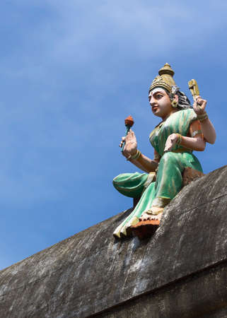 KUMBAKONAM, INDIA - OCTOBER 12, 2013: Mahalingeswarar Temple. Statue of goddess Lakshmi on the temple wall. She brings prosperity to the temple.のeditorial素材