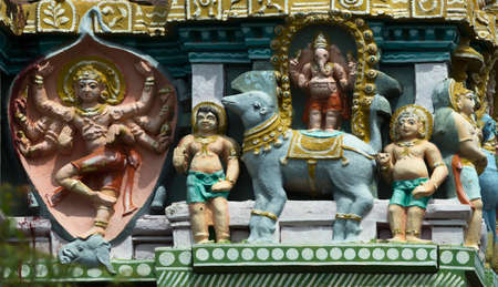 KUMBAKONAM, INDIA - OCTOBER 12, 2013: Mahalingeswarar Temple. Statue composition on Gopuram. The figure on the left is Lord Shiva, the slayer of the elephant, who skinned the animal and wore the skin as a garment.The figure on the right is Lord Ganesha sのeditorial素材