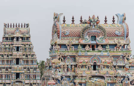 Trichy, India - October 15, 2013: two gopurams of the temple in one shot, pastel colored with plenty of statues including  the main Ranganathar depiction of Vishnu resting on the snake.のeditorial素材