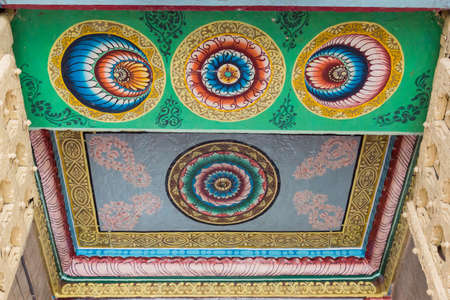 Trichy, India - October 15, 2013: Ceiling paintings in bright yellow, red and blue colors show circles, mandalas with lotus symbols. Entrance gopuram of Ranganathar Temple.のeditorial素材
