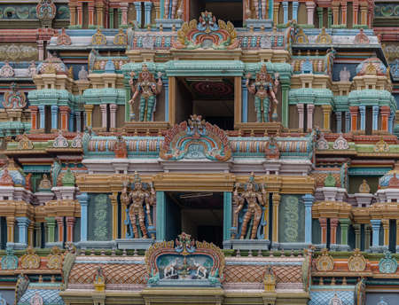 Trichy, India - October 15, 2013: Detail of the massive Rajagopuram of Ranganathar Temple. Focus on a couple of the openings protected by Dwarapalakas. Pastel colors entire photo of pillars and statues. Lakshmi on lotus showered by elephants.のeditorial素材