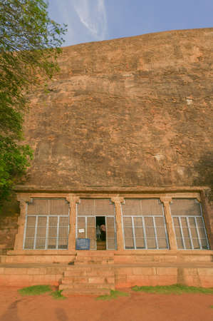 Chettinad, India - October 15, 2013: Chithannavasal Cave Jain Temple is hewn into a huge rock. A screen fills a pillared gate in front of the cave opening; the only temple item visible from outside. Rock wall in photo.のeditorial素材