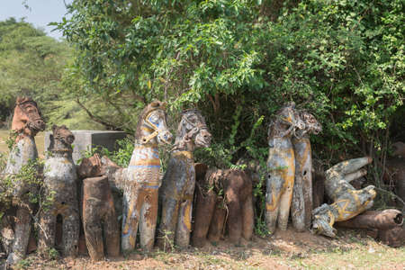 Chettinad, India - October 16, 2013: Ayyanar, village protector Horse shrine of Namunasamudran. Line of clay horses in different stages of deterioration.のeditorial素材
