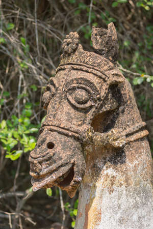 Chettinad, India - October 16, 2013: Ayyanar, village protector, Horse shrine of Namunasamudran. Old clay horse head is brown and beige with black mold spots.のeditorial素材