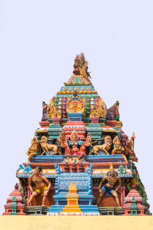 Chettinad, India - October 17, 2013: Statue of Devi Durga and lions on colorful Vimanam of Mariamman temple in Kothamargalam. She represents female power.のeditorial素材
