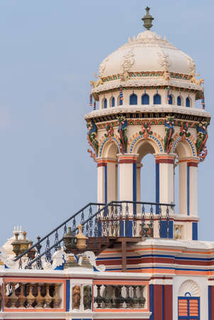 Chettinad, India - October 17, 2013: Chidambara Palace in Kadiapatti. View on lookout tower against blue sky. Combination of colors as decoration.のeditorial素材