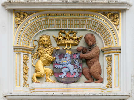Brugge, Belgium - August 10, 2016: Portrait of the Bruges Coat of Arms in three dimensional mural on facade of medieval Palace of Justice. Gold, Brown, Blue and more.のeditorial素材