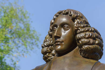 Amsterdam, the Netherlands - August 16, 2016: The famous philosopher Baruch Spinoza has his statue near the Bijvoetbrug. Detail of bronze shows serious looking man with long curly hair.のeditorial素材