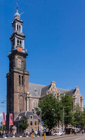 Amsterdam, the Netherlands - August 16, 2016: The Westerkerk against blue sky with lots of people and traffic in front.のeditorial素材