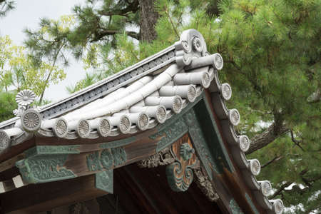 Kyoto, Japan - September 14, 2016: Detail of roof cover, structure and of eave at Imperial palace. Set against the green of a pine tree.のeditorial素材