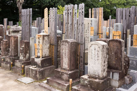 Kyoto, Japan - September 15, 2016: Adjacent to the Shinnyo-do Buddhist Temple is a large cemetery serving the Buddhist community. Row of browned, older tombstones with plenty of wooden memorial tablets, called To-Ba.のeditorial素材