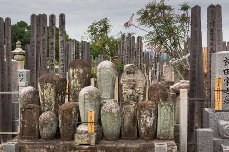 Kyoto, Japan - September 15, 2016: Adjacent to the Shinnyo-do Buddhist Temple is a large cemetery serving the Buddhist community. A group of old cylindrical tombstones are set together.のeditorial素材