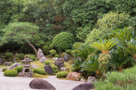 Kyoto, Japan - September 16, 2016: View in Yuzen-en garden at Chion-in Buddhist Temple. Lantern, pebble-field and plenty of green plants and trees.のeditorial素材