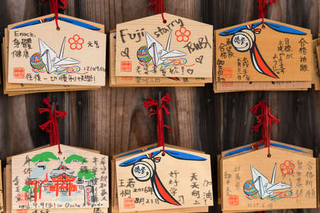 Kyoto, Japan - September 17, 2016: Closeup of six wooden prayer boards at Fushimi Inari Taisha Shinto Shrine. Left by worshipers writing down their wishes and pleas for the spirits of the ancestors.のeditorial素材