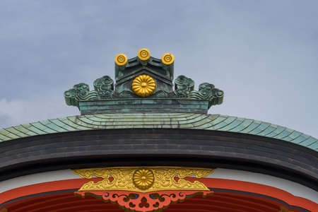 Kyoto, Japan - September 17, 2016: Fushimi Inari Taisha Shinto Shrine. The crest of a roof shines in...