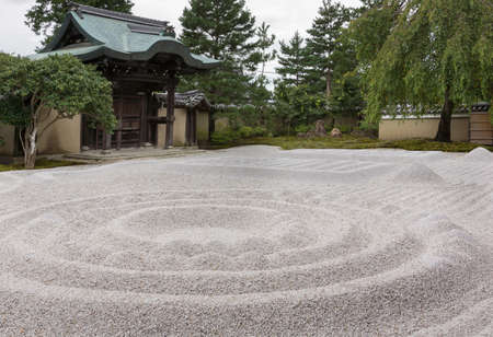 Kyoto, Japan - September 19, 2016: The famous Zen garden at the Kodai-ji Buddhist Temple sits between the hall and the historic main entrance gate. It consists of beige pebbles, raked in geometric figures.のeditorial素材
