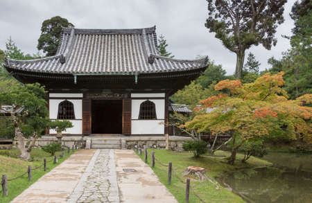 Kyoto, Japan - September 19, 2016: Smaller hall of the Kodai-ji Buddhist Temple complex sits in a beautiful garden which starts to show autumn colors. Gray sky.のeditorial素材