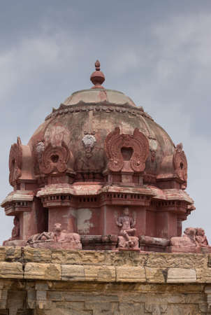 Dindigul, India - October 23, 2013: The Vimanam at the abandoned ruinous Shiva Temple on the Rock in Dindigul. Red painted dome features statue of sitting Shiva with foot on the dwarf, ignorance, and Nandi the bull.のeditorial素材
