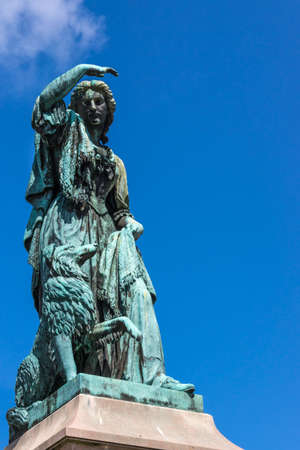 Inverness, Scotland - June 1, 2012: Closeup of greenish bronze Flora MacDonald statue shows the...