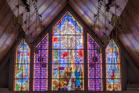 Auckland, New Zealand - March 4, 2017: Mostly blueish large stained glass window at front of Holy Trinity Cathedral features Polynesian and Maori symbols around Christian themes.のeditorial素材