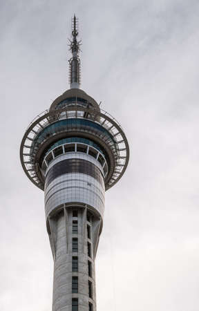 Auckland, New Zealand - March 5, 2017: Closeup of tall communication and restaurant Sky Tower top under gray sky.のeditorial素材