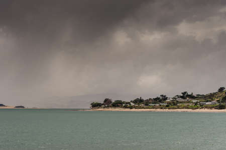 Bay of Islands, New Zealand - March 7, 2017: Opononi town on shore of Hokianga Harbour. Hokianga...
