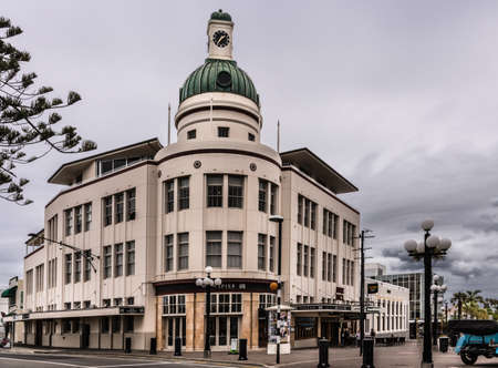Napier, New Zealand - March 9, 2017: Lone Star office building with clock tower at Emerson and boardwalk intersection. Street scene with heave clouds.のeditorial素材