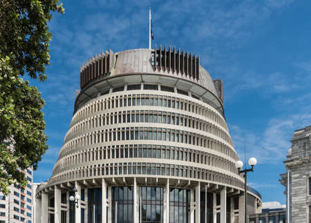 Wellington, New Zealand - March 10, 2017: Closeup of Beehive Administrative Government building under blue sky. One green tree.のeditorial素材