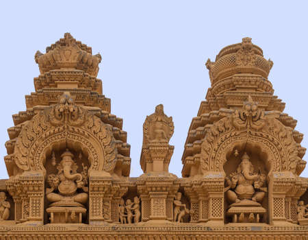 Nanjangud, India - October 26, 2013: Double Niche in beige elaborately decorated sandstone at Srikanteshwara Temple showing both statue of sitting Lord Ganesha. Sexual imagery nearby.のeditorial素材