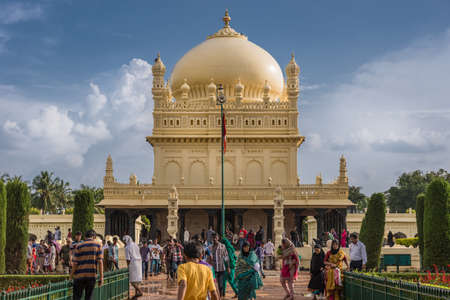 Mysore, India - October 26, 2013: Cream yellow Tipu Sultan mausoleum with dome under heavy...
