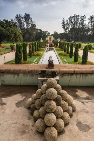 Mysore, India - October 26, 2013: Grounds and green and red park of Tipu Sultan Summer Palace, named...