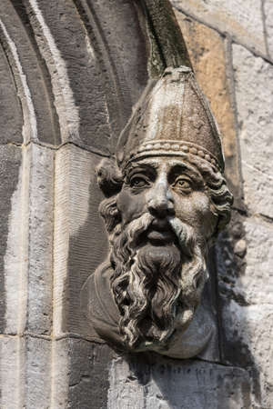 Dublin, Ireland - August 7, 2017: Closeup of statue of bishop head on side of entrance to church at The Castle.のeditorial素材