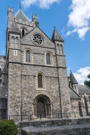Dublin, Ireland - August 7, 2017: Gray stone bell tower of Christ Church Cathedral against blue sky with white clouds.のeditorial素材