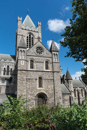 Dublin, Ireland - August 7, 2017: Gray stone bell tower and chancel of Christ Church Cathedral...