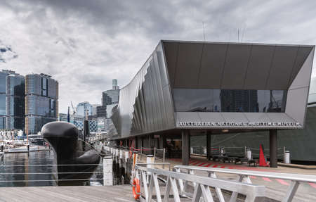 Sydney, Australia - March 21, 2017: Entrance to modern black addition to National Maritime Museum under heavy cloudscape.のeditorial素材