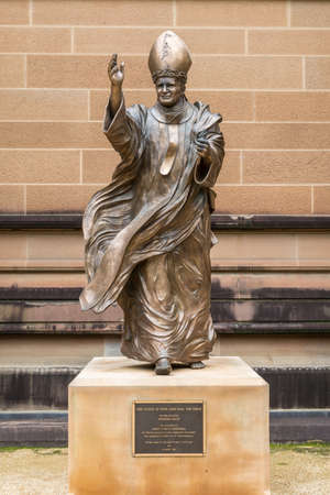 Sydney, Australia - March 23, 2017: Close up of Bronze statue of Pope John Paul The Great on side of brown facade of Saint Marys Cathedral. Sculpted by Fiorenzo Bacci.のeditorial素材