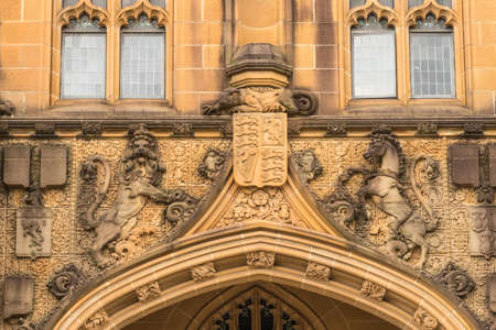 Sydney, Australia - March 25, 2017: Closeup of brown stone detail of historic Nicholson Museum facade above entrance with emblems, lion, horse, monster.のeditorial素材